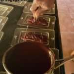 pouring chocolate into mold to make tablets