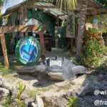 front view of the office found in downtown cahuita next to miss Edith's resturant with the harbor in the back. You can appreciate a sculpure of a leather back turtle in the front made out of concrete.