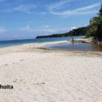 peresozo river mouth in cahuita national park. Wite sand with the national park point in the background.