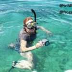 girl in the watter with her camera ready to take pictures of the coral reef and sea life in Cahuita National Park